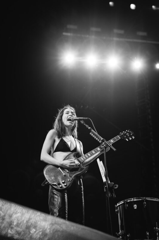 HAIM live in concert in San Diego California, Petco Park. Danielle Haim singing and performing on stage. Professional live music photography by Evan Denworth.