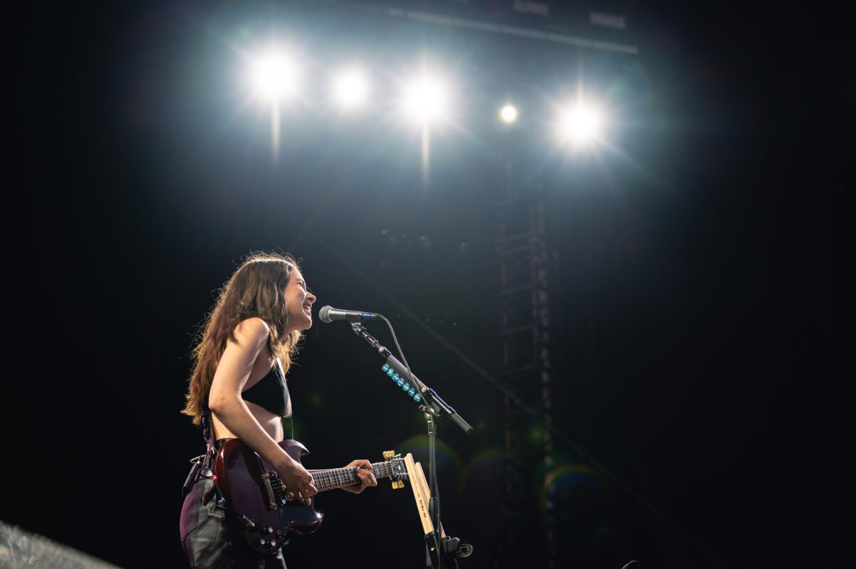 HAIM live in concert in San Diego California, Petco Park. Danielle Haim singing and performing on stage. Professional live music photography by Evan Denworth.