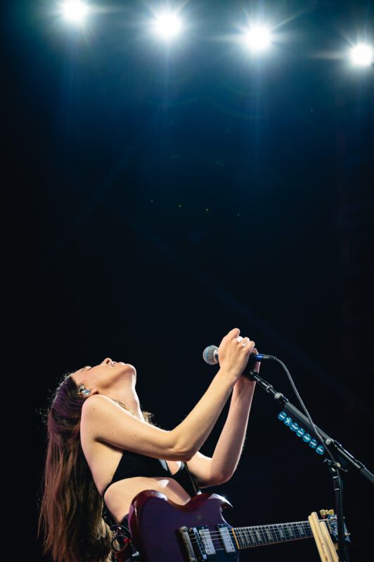 HAIM live in concert in San Diego California, Petco Park. Danielle Haim singing and performing on stage. Professional live music photography by Evan Denworth.