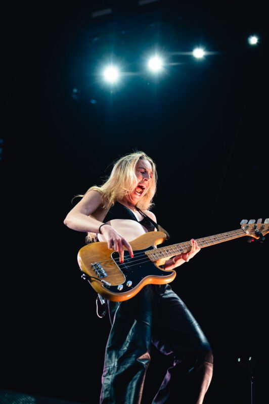 HAIM live in concert in San Diego California, Petco Park. Este Haim performing on stage. Professional live music photography by Evan Denworth.