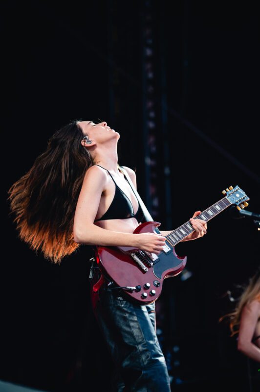 HAIM live in concert in San Diego California, Petco Park. Danielle Haim performing on stage. Professional live music photography by Evan Denworth.
