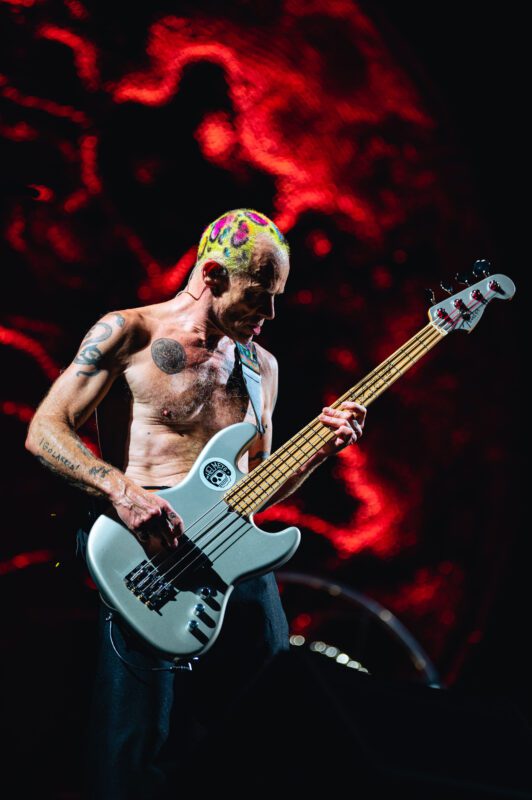 Red Hot Chili Peppers live in concert in San Diego California, Petco Park. Flea performing on stage. Professional live music photography by Evan Denworth.
