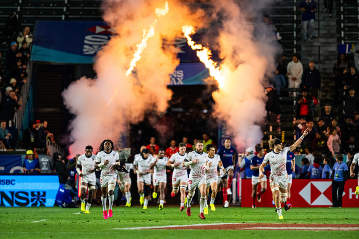 2024 HSBC SVN'S Rugby Tournament in Los Angeles at Dignity Health Sports Park. USA Rugby professional rugby player sports action photography. High-impact commercial sports imaging for team branding. Rugby player sprinting with ball, stiff-arming defender. Fast shutter speed sports photography capturing breakaway speed.