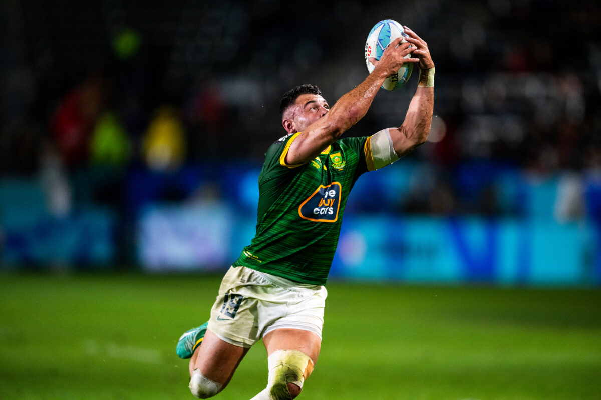 2024 HSBC SVN'S Rugby Tournament in Los Angeles at Dignity Health Sports Park. South Africa Rugby professional rugby player sports action photography. High-impact commercial sports imaging for team branding. Rugby player sprinting with ball, stiff-arming defender. Fast shutter speed sports photography capturing breakaway speed.