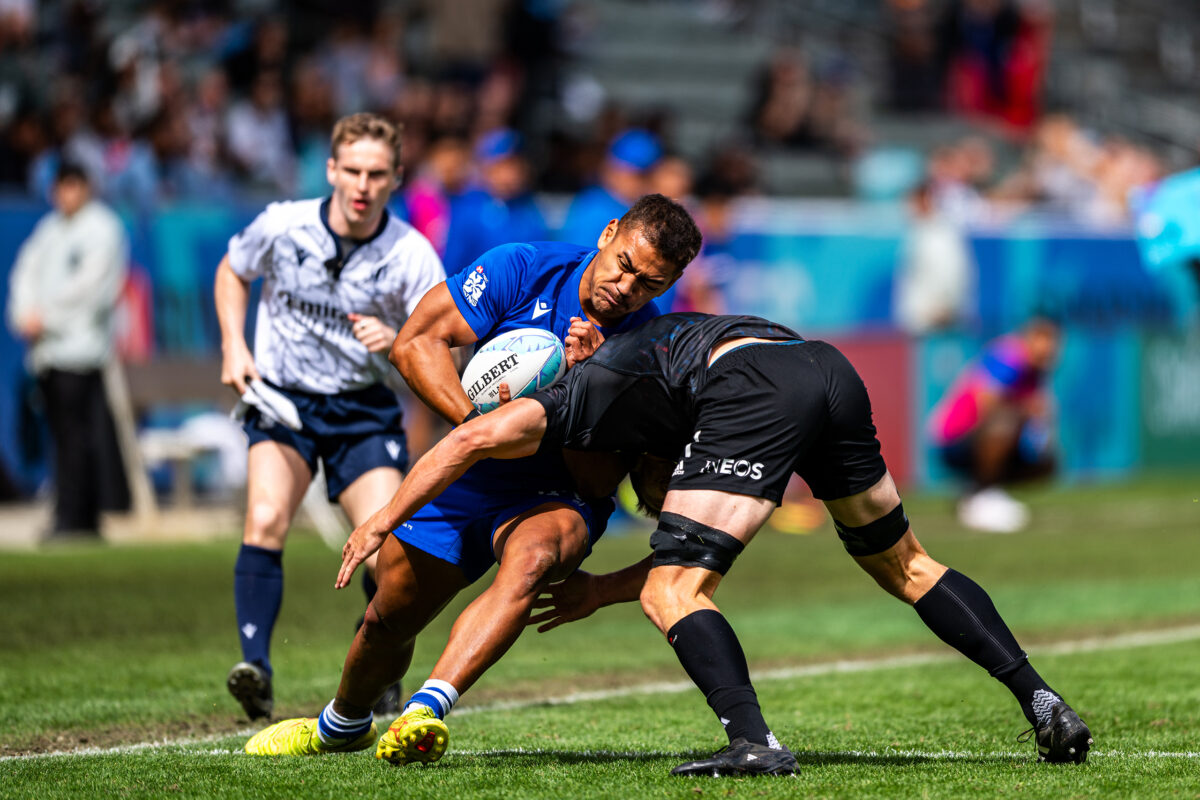 2024 HSBC SVN'S Rugby Tournament in Los Angeles at Dignity Health Sports Park. Samoa Rugby professional rugby player sports action photography. High-impact commercial sports imaging for team branding. Rugby player sprinting with ball, stiff-arming defender. Fast shutter speed sports photography capturing breakaway speed.
